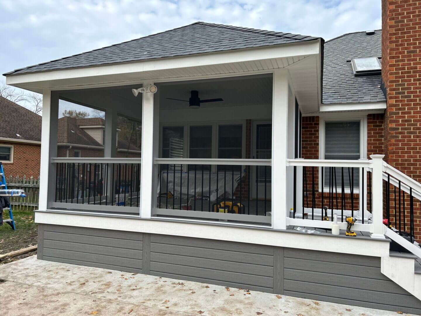 Custom screened porch with white railing and roof built by B&B Decks in Virginia Beach