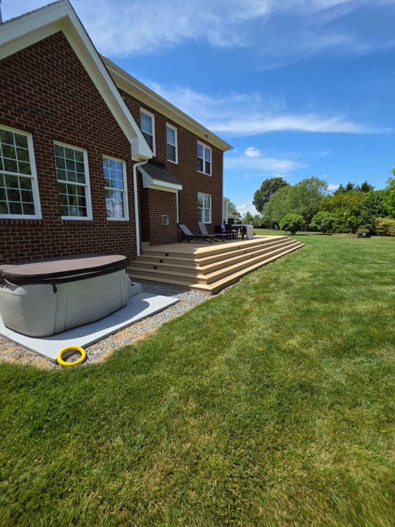 Custom waterfront-view outdoor living space and composite deck in Kingsmill Virginia