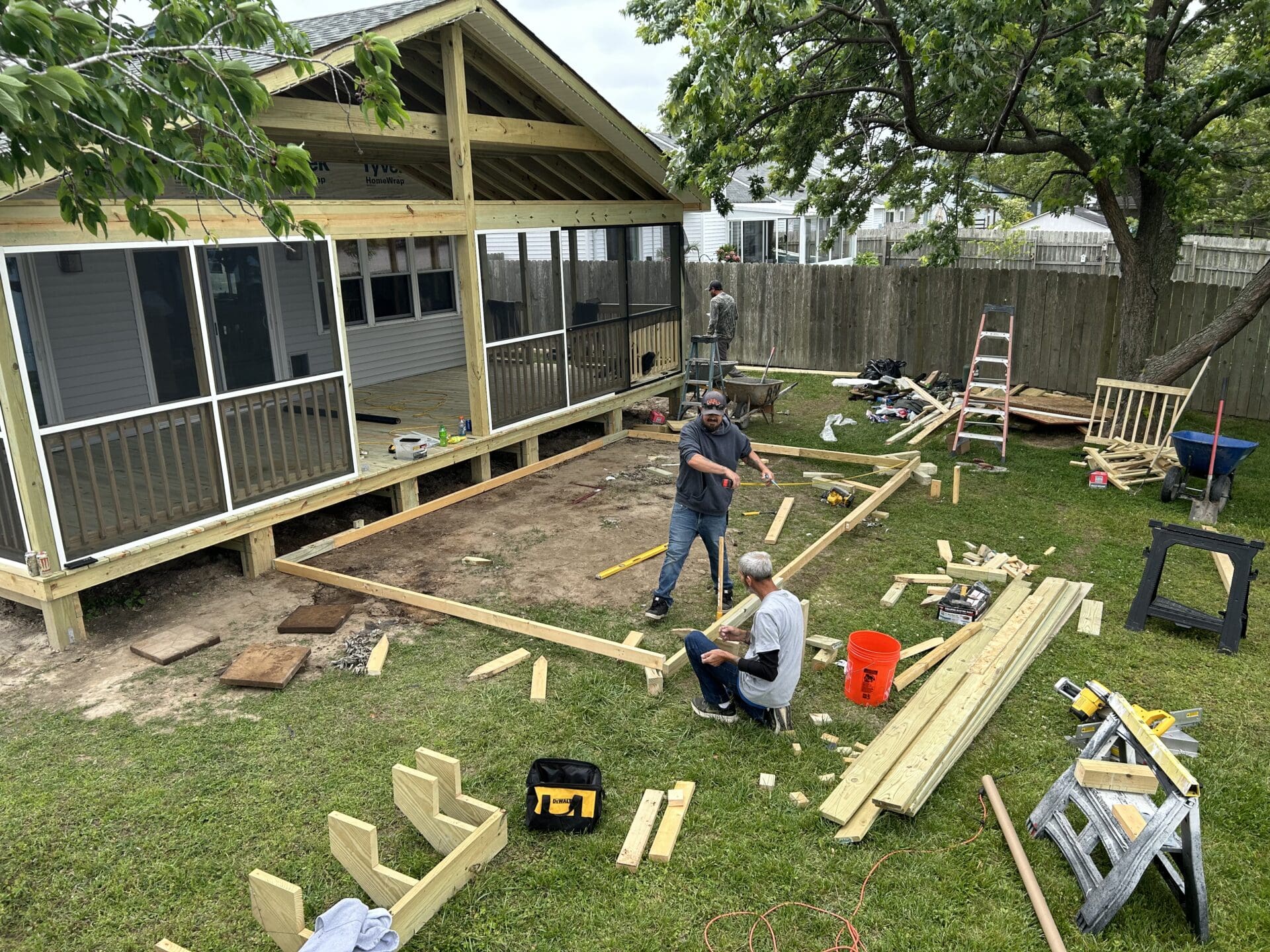 Multi-level composite deck with seating in a Newport News backyard, built by B&B Decks