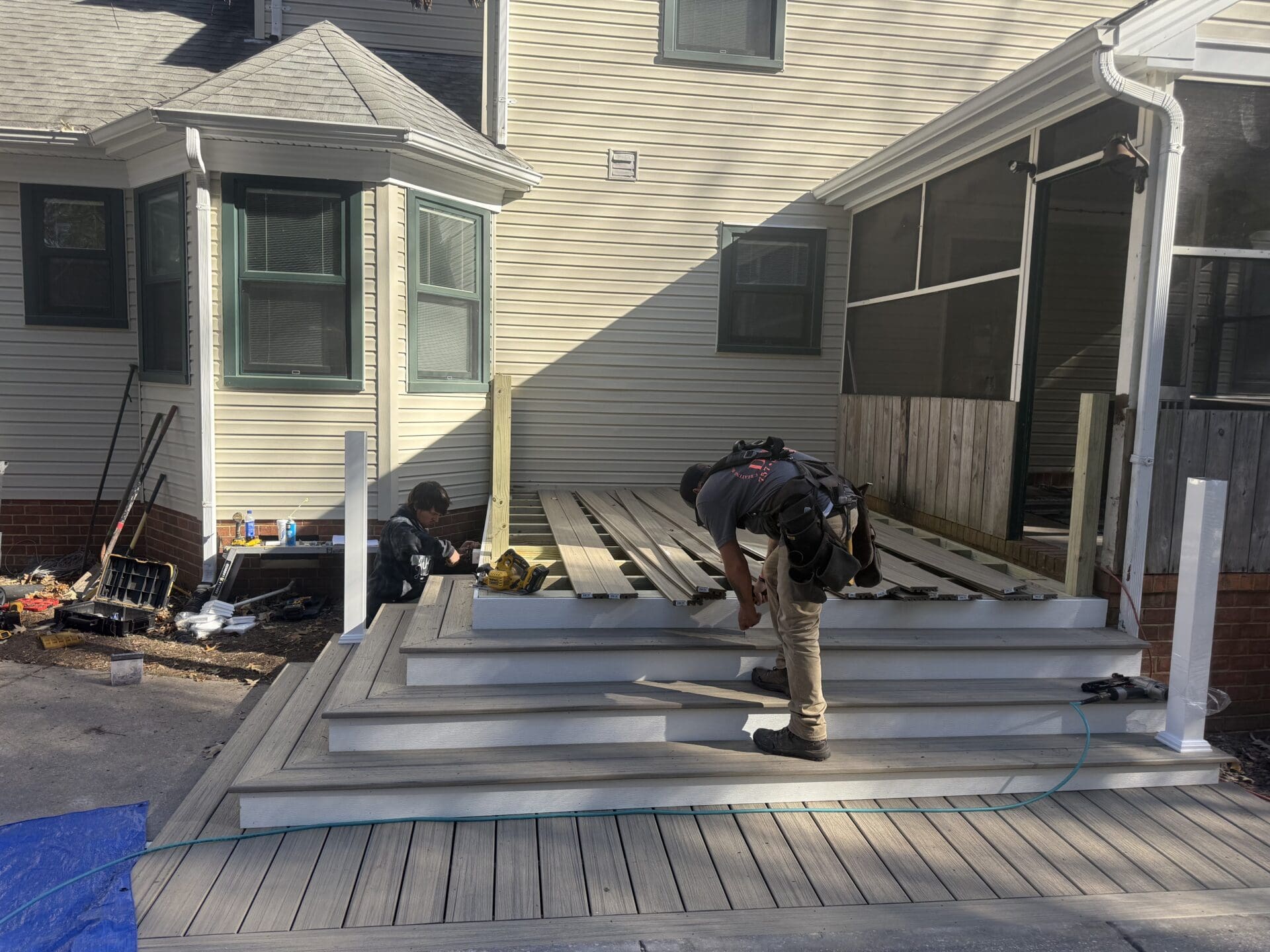 Composite deck with railing in a Hampton waterfront backyard, built by B&B Decks